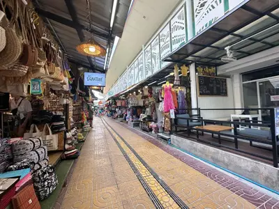 an aisle of a store in a market with shops at Blue Flow Hostel in Phi Phi Don