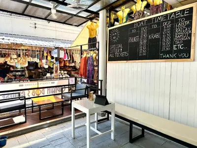 a shop with a bench and a chalkboard on the wall at Blue Flow Hostel in Phi Phi Don