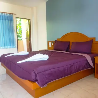 a bedroom with a large bed with purple sheets at Pailin Hill Hotel Patong in Patong Beach