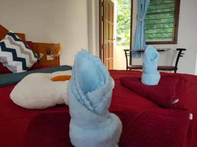 a bedroom with a bed with stuffed animals on it at Pailin Hill Hotel Patong in Patong Beach