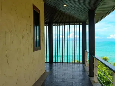 a balcony with a view of the ocean at Patong 4BD sea view BOOM party&cozy pool villa in Ban Nakhale