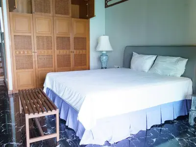 a bedroom with a large white bed and a lamp at Patong 4BD sea view BOOM party&cozy pool villa in Ban Nakhale