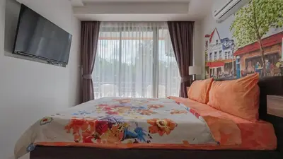a bedroom with a bed and a flat screen tv at Квартира in Mai Khao Beach