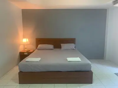 a bedroom with a bed with two towels on it at Kamalaburi Guesthouse in Kamala Beach