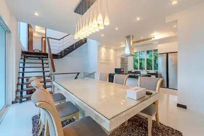 a dining room with a table and chairs at White Villa Patong in Patong Beach