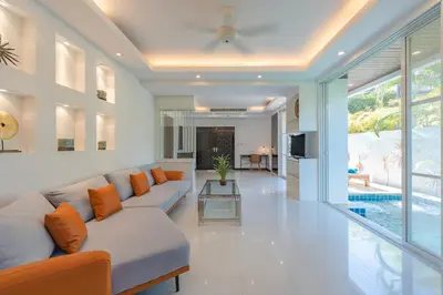 a living room with a couch and a table at White Villa Patong in Patong Beach