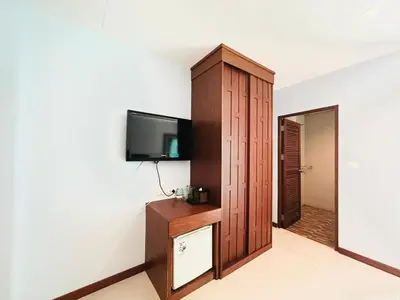a room with a flat screen tv on a wall at Cokoon Deva Patong Hotel in Patong Beach