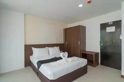 a bedroom with a bed with a stuffed animal on it at Destination Patong in Patong Beach