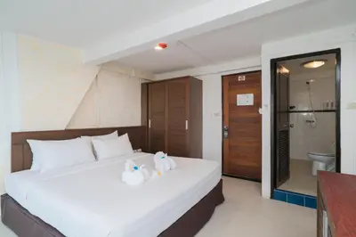 two stuffed animals sitting on a bed in a room at Destination Patong in Patong Beach
