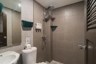 a bathroom with a shower and a toilet and a sink at Destination Patong in Patong Beach