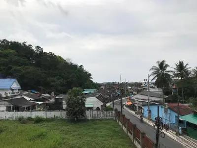 a view of a town with houses and a train at Apartment kata in Kata Beach