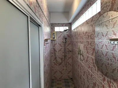 a bathroom with a shower with red tile at Apartment kata in Kata Beach