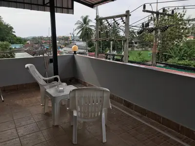 a table and chairs on a balcony with a view at Apartment kata in Kata Beach