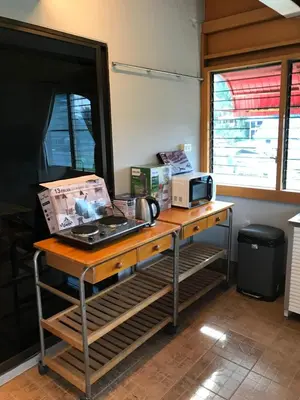 a desk with a laptop and a microwave on it at Apartment kata in Kata Beach