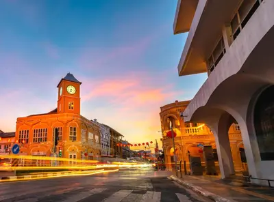 a city street with a clock tower on a building at La Vista Patong Hotel in Patong Beach