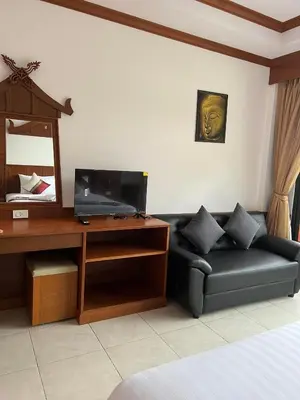 a living room with a couch and a desk at Vice City guest house in Patong Beach