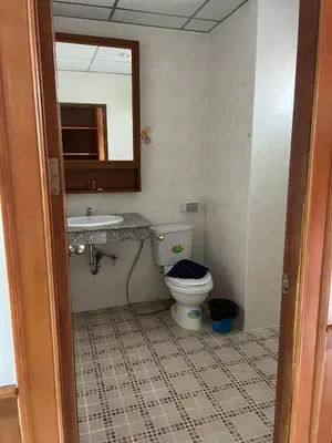 a bathroom with a toilet and a sink and a mirror at Vice City guest house in Patong Beach