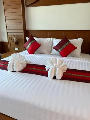 a bedroom with two towels on a bed at Vice City guest house in Patong Beach