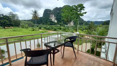 a balcony with two chairs and a glass table at 8 Palm Villa - Large Private Pool Villas in Aonang in Ao Nang Beach