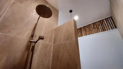 a shower in a bathroom with a wooden wall at 8 Palm Villa - Large Private Pool Villas in Aonang in Ao Nang Beach