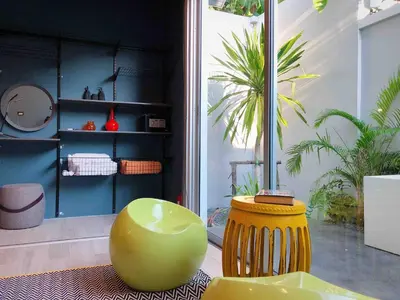 a room with a green ottoman and a yellow stool at Contemporary 3bd Safari Pool Villa Near Nai Yang Beach in Ban Bo Han