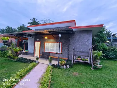a small house with a red roof at Da-Kanda Boutique in Klong Muang Beach