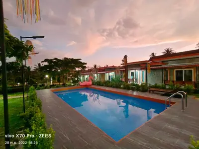 a swimming pool in front of a house at Da-Kanda Boutique in Klong Muang Beach