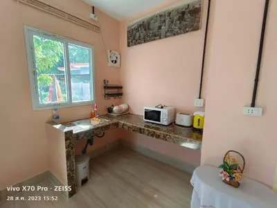 a room with a counter with a microwave and a window at Da-Kanda Boutique in Klong Muang Beach