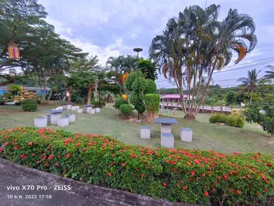 a park with a bunch of flowers and trees at Da-Kanda Boutique in Klong Muang Beach