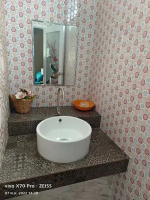 a bathroom with a white sink and a mirror at Da-Kanda Boutique in Klong Muang Beach