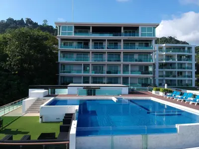 a large building with a swimming pool in front of it at Sea view apartment at The Privilege by Lofty in Patong Beach