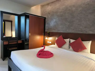 a bedroom with a bed with a red swan on it at The Morning mini house aonang - 15-45 years old only in Ao Nang Beach