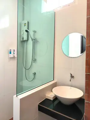 a bathroom with a sink and a glass shower at The Morning mini house aonang - 15-45 years old only in Ao Nang Beach