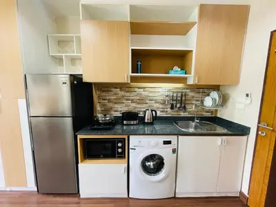 a kitchen with a refrigerator and a washing machine at Brand Naithon CondoC404 in Nai Thon Beach