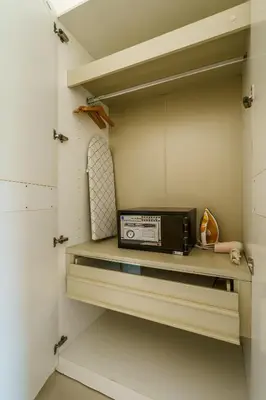 a microwave sitting on a shelf in a closet at Chic Condominium by Redfox Hospitality in Karon Beach
