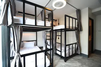 a room with four bunk beds in a hostel at KOKO Party Hostel 18-40 in Ao Nang Beach