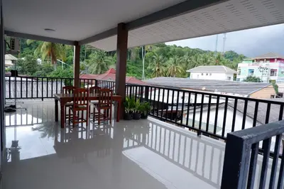 a balcony with a table and chairs on it at WS HOUSE KRABI in Ban Ko Kwang