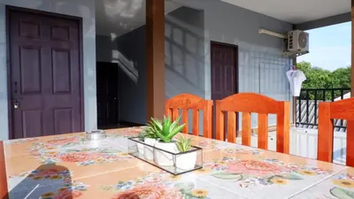 a dining room table with a plant on it at WS HOUSE KRABI in Ban Ko Kwang