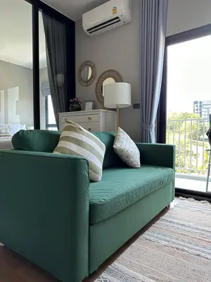 a green couch in a living room with a window at Title V Mountain View Pool View Gym Hammam in Rawai Beach