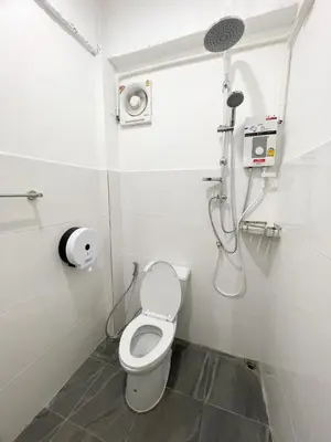 a bathroom with a toilet and a shower at Magic Hostel in Phi Phi Don