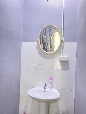 a bathroom with a sink and a mirror on the wall at Magic Hostel in Phi Phi Don