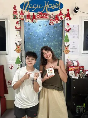 a woman and a boy posing for a picture at a christmas party at Magic Hostel in Phi Phi Don