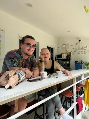 a man and a woman sitting at a table at Magic Hostel in Phi Phi Don