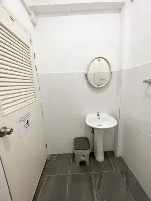 a bathroom with a sink and a toilet and a mirror at Magic Hostel in Phi Phi Don