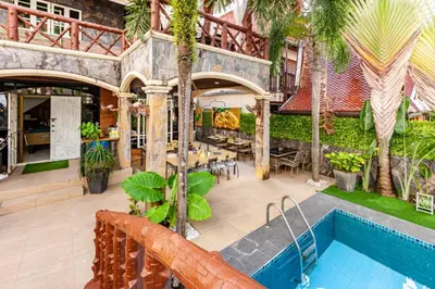 an indoor courtyard with a pool and a restaurant at Villa Cologne​ @Nanai Villa in Patong Beach