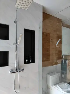 a bathroom with a shower and a toilet and a sink at Phuket Jungle Experience Resort in Karon Beach