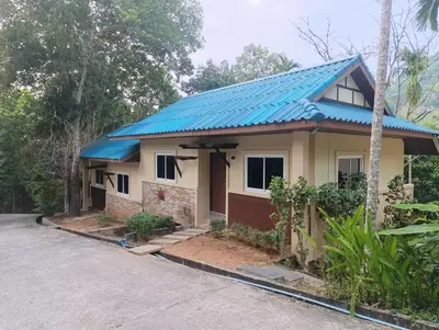 a house with a blue roof at Phuket Jungle Experience Resort in Karon Beach