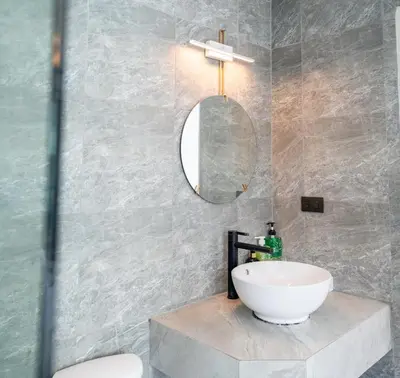 a bathroom with a white sink and a mirror at Meow Cat Cafe & Hotel in Patong Beach