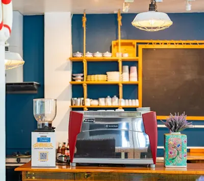 a kitchen with a counter with a microwave on a table at Meow Cat Cafe & Hotel in Patong Beach
