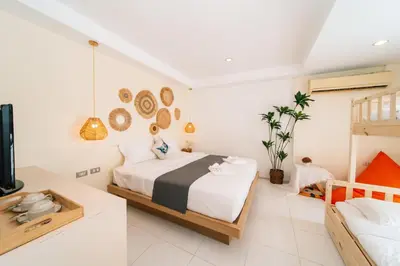 a bedroom with a bed and a tv in it at Catnip Seaside Hotel&Cafe in Ban Huai Luk (1)